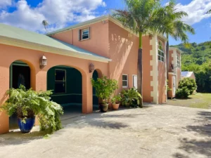 The driveway of a pink STX property